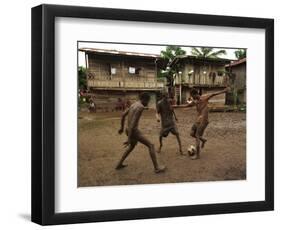 A Group of Panamanian Youths Slide Through the Mud During a Pick-Up Game of Soccer-null-Framed Photographic Print