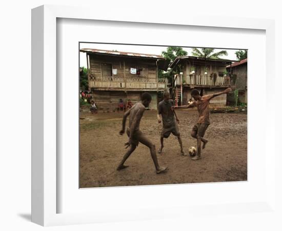 A Group of Panamanian Youths Slide Through the Mud During a Pick-Up Game of Soccer-null-Framed Photographic Print