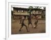 A Group of Panamanian Youths Slide Through the Mud During a Pick-Up Game of Soccer-null-Framed Photographic Print