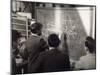 A Group of Scientists Study a Problem by Using Diagrams on a Blackboard-Henry Grant-Mounted Photographic Print