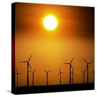 A Group of Wind Turbines are Silhouetted by the Setting Sun-Charlie Riedel-Stretched Canvas