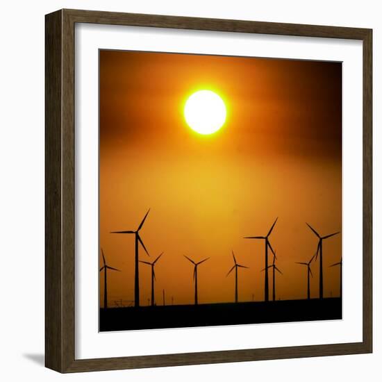 A Group of Wind Turbines are Silhouetted by the Setting Sun-Charlie Riedel-Framed Photographic Print