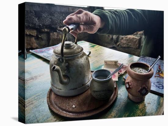 A Hand on a Teapot and Yerba Mate at Refugio Piltriquitron in the Andes of Patagonia, Argentina-Maureen Eversgerd-Stretched Canvas