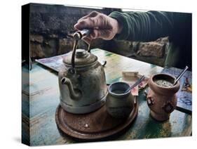 A Hand on a Teapot and Yerba Mate at Refugio Piltriquitron in the Andes of Patagonia, Argentina-Maureen Eversgerd-Stretched Canvas