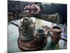 A Hand on a Teapot and Yerba Mate at Refugio Piltriquitron in the Andes of Patagonia, Argentina-Maureen Eversgerd-Mounted Photographic Print