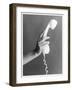 A Hand with Manicured Finger Nails Hold Up a White Telephone Handset-null-Framed Photographic Print