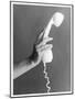 A Hand with Manicured Finger Nails Hold Up a White Telephone Handset-null-Mounted Photographic Print