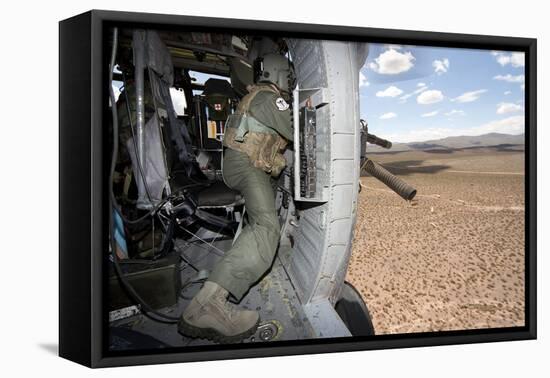 A Hh-60G Pave Hawk Gunner Fires His Gau-17 Machine Gun-null-Framed Stretched Canvas