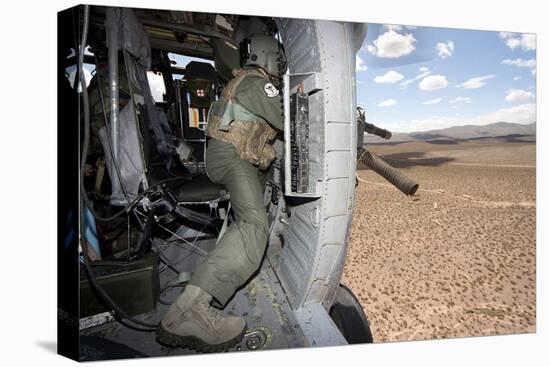 A Hh-60G Pave Hawk Gunner Fires His Gau-17 Machine Gun-null-Stretched Canvas