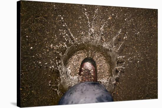 A Hiking Boot Splashing in a Puddle in a Parking Lot in Boulder, Colorado-Sergio Ballivian-Stretched Canvas