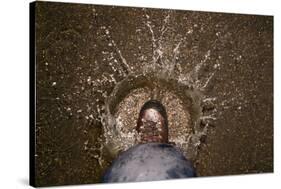 A Hiking Boot Splashing in a Puddle in a Parking Lot in Boulder, Colorado-Sergio Ballivian-Stretched Canvas