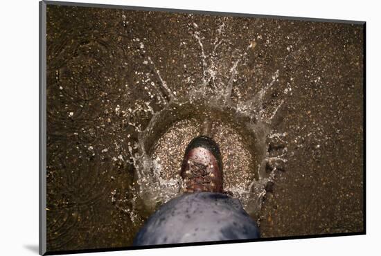 A Hiking Boot Splashing in a Puddle in a Parking Lot in Boulder, Colorado-Sergio Ballivian-Mounted Photographic Print