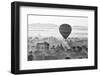 A hot air balloon flies over a trees and a temple at sunrise on a misty morning, Bagan, Myanmar-Tim Mannakee-Framed Photographic Print