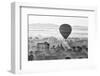 A hot air balloon flies over a trees and a temple at sunrise on a misty morning, Bagan, Myanmar-Tim Mannakee-Framed Photographic Print