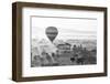 A hot air balloon flies over a trees and a temple at sunrise on a misty morning, Bagan, Myanmar-Tim Mannakee-Framed Photographic Print