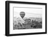 A hot air balloon flies over a trees and a temple at sunrise on a misty morning, Bagan, Myanmar-Tim Mannakee-Framed Photographic Print