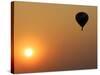 A Hot-Air Balloon Flies Over the Peremilovo Village-null-Stretched Canvas