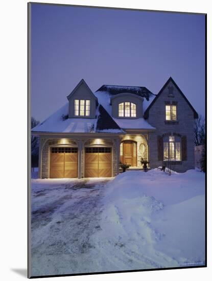 A House in a Snow Covered Landscape Lit Up at Night-null-Mounted Photographic Print