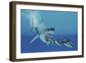 A Huge Megalodon Shark Swims after a Pod of Striped Dolphins-null-Framed Art Print