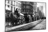 A Line Of Horse-Drawn Wagons Hauling Snow In New York City-null-Mounted Art Print
