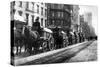 A Line Of Horse-Drawn Wagons Hauling Snow In New York City-null-Stretched Canvas