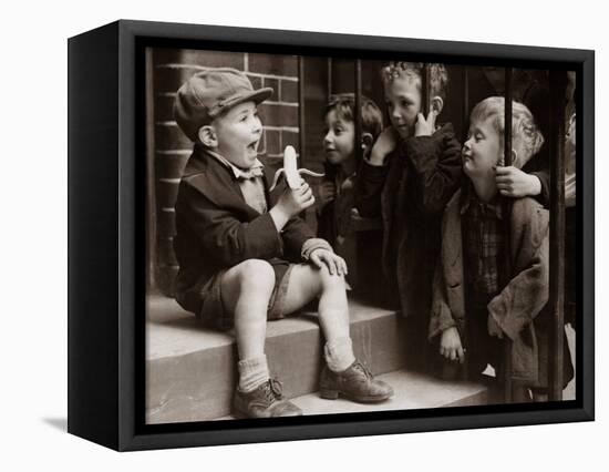 A Little Boy Holding a Banana Whilst Other Children Gaze Longingly at It-null-Framed Stretched Canvas