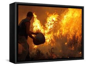 A Local Resident Throws a Bucket of Water on a Forest Fire-null-Framed Stretched Canvas