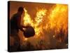 A Local Resident Throws a Bucket of Water on a Forest Fire-null-Stretched Canvas