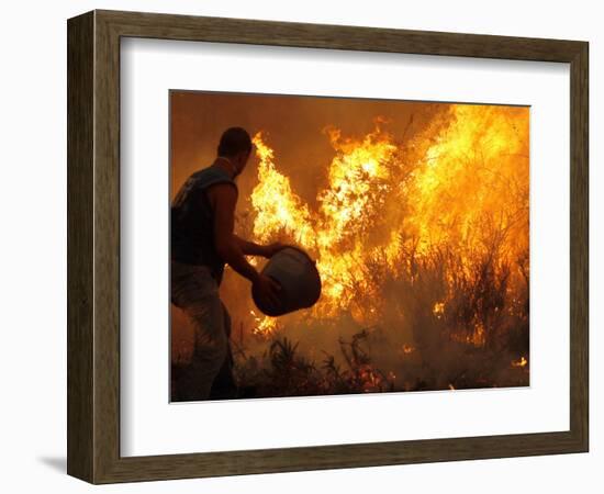 A Local Resident Throws a Bucket of Water on a Forest Fire-null-Framed Photographic Print