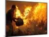 A Local Resident Throws a Bucket of Water on a Forest Fire-null-Mounted Photographic Print