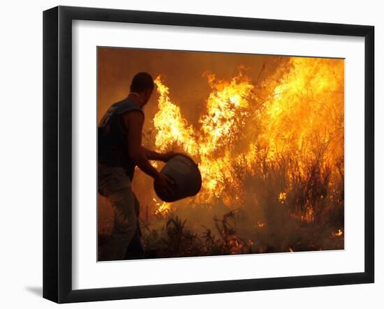 A Local Resident Throws a Bucket of Water on a Forest Fire-null-Framed Photographic Print