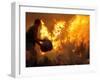 A Local Resident Throws a Bucket of Water on a Forest Fire-null-Framed Photographic Print