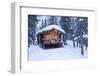 A log cabin is decorated with holiday lights and a green wreath on the door, Alaska-Design Pics-Framed Photographic Print