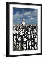 A Lone Android with a Human Flesh Colored Face Amongst a Crowd of Robots-null-Framed Art Print