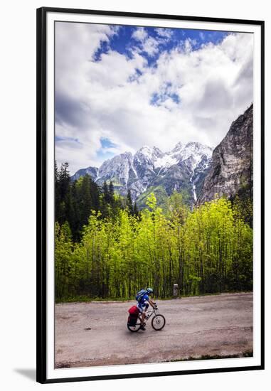 A Lone Cyclist Travels Along a Mountain Road with Trees and the Julian Alps in the Background-Sean Cooper-Framed Premium Photographic Print