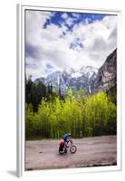 A Lone Cyclist Travels Along a Mountain Road with Trees and the Julian Alps in the Background-Sean Cooper-Framed Premium Photographic Print