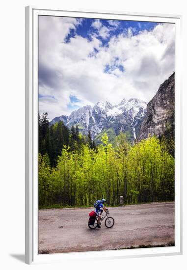 A Lone Cyclist Travels Along a Mountain Road with Trees and the Julian Alps in the Background-Sean Cooper-Framed Premium Photographic Print