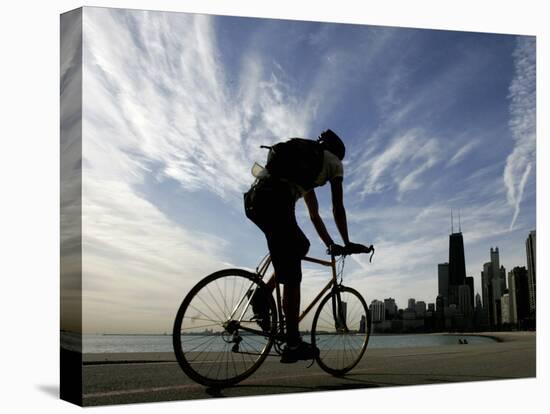 A Lone Cyclists Pedals Along Lake Michigan-null-Stretched Canvas