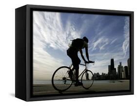 A Lone Cyclists Pedals Along Lake Michigan-null-Framed Stretched Canvas