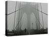 A Lone Runner Makes His Way Across the Fog-Shrouded Brooklyn Bridge Christmas Morning-null-Stretched Canvas