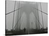 A Lone Runner Makes His Way Across the Fog-Shrouded Brooklyn Bridge Christmas Morning-null-Stretched Canvas