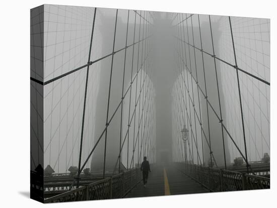 A Lone Runner Makes His Way Across the Fog-Shrouded Brooklyn Bridge Christmas Morning-null-Stretched Canvas