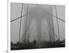 A Lone Runner Makes His Way Across the Fog-Shrouded Brooklyn Bridge Christmas Morning-null-Framed Photographic Print