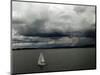 A Lone Sailboat Makes its Way Along Folsom Lake as Heavy Storm Clouds Approach-null-Mounted Photographic Print