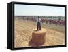 A Lone Spectator Watches the Pack Ride by from the Top of a Bale of Hay-null-Framed Stretched Canvas