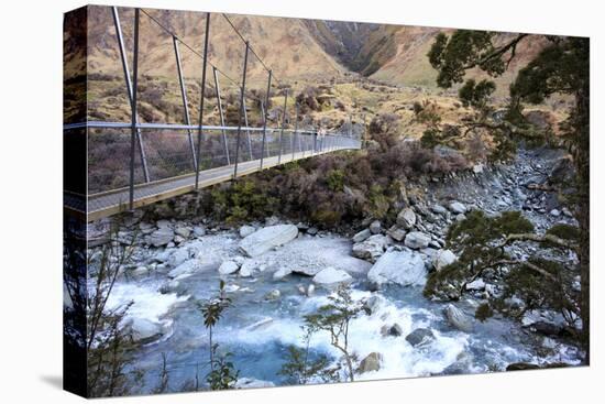 A Long Suspension Bridge over a River on the Fox Glacier Track, Wanaka, South Island, New Zealand-Paul Dymond-Stretched Canvas