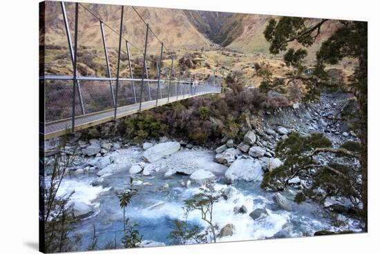 A Long Suspension Bridge over a River on the Fox Glacier Track, Wanaka, South Island, New Zealand-Paul Dymond-Stretched Canvas