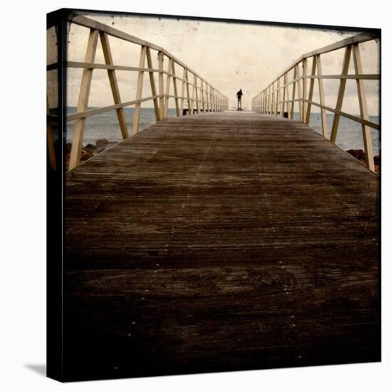 A Long Wooden Walkway at the Sea with a Figure Standing in the Distance-Luis Beltran-Stretched Canvas