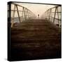 A Long Wooden Walkway at the Sea with a Figure Standing in the Distance-Luis Beltran-Stretched Canvas