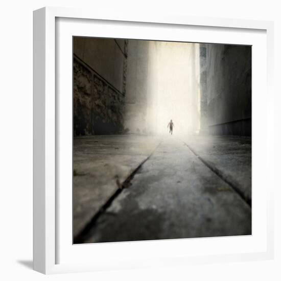 A Low Level View of a Boy Running Along the Street-Luis Beltran-Framed Photographic Print